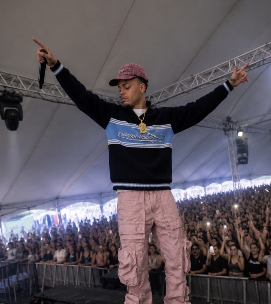 CJ WestCoast with arms outstretched in front of a packed festival tent